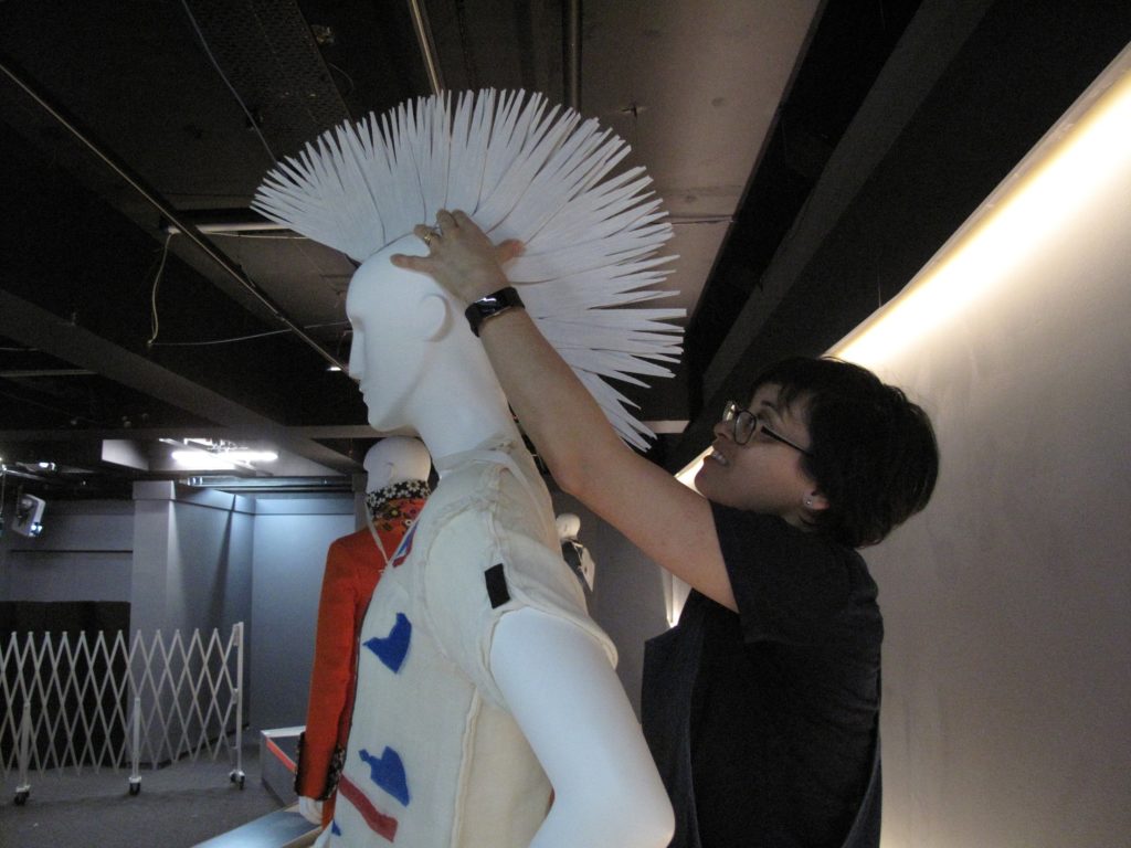 Rachel Tu, Collections Manager (LACMA) placing the wig for Vivienne Westwood and Malcolm McLaren’s punk outfit